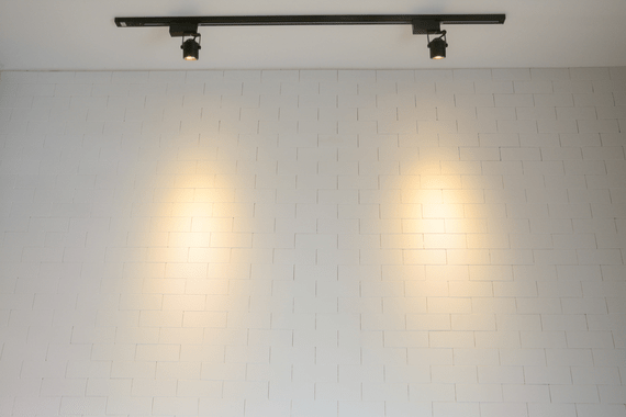 Track lighting against brick wall 