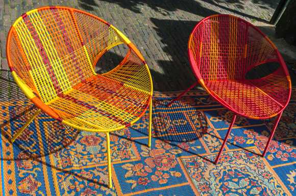  Two brightly colored chairs on an equally brightly colored rug