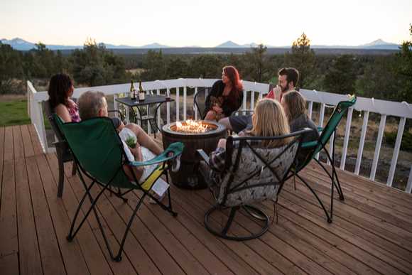 Family enjoying fire pit on patio