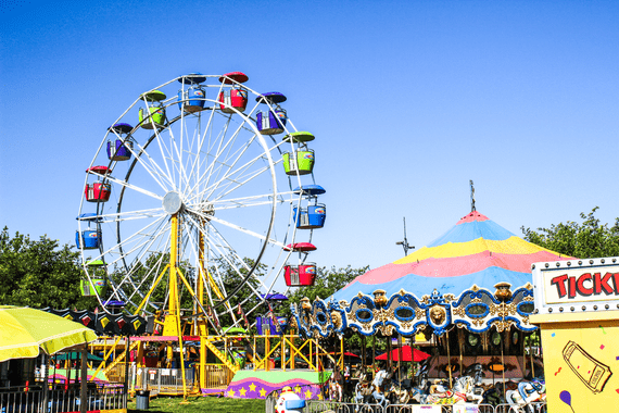 carnival with ferris wheel and other rides