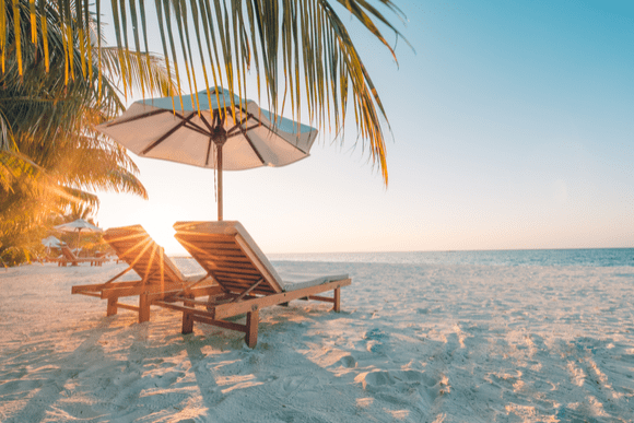 image of a beach as the sun is rising 