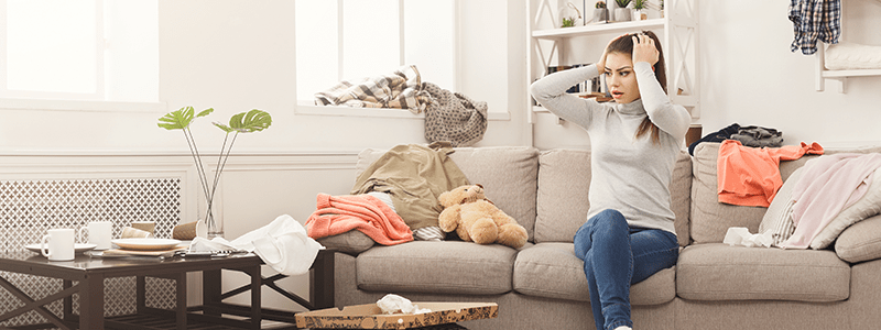 woman surrounded by clutter