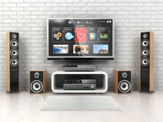 Surround sound speakers in front of television and tv stand.