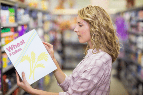 woman in grocery store shopping for cereal