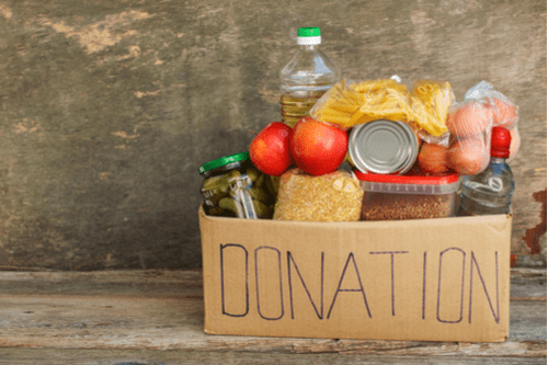 Box labeled “donation” with different food items inside. 