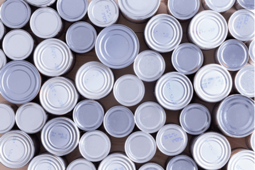 Overhead shot of the top of sealed aluminum cans.