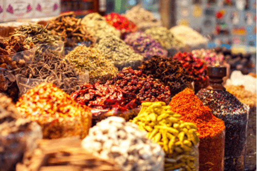 Stacks of different spices in an open-air market. 