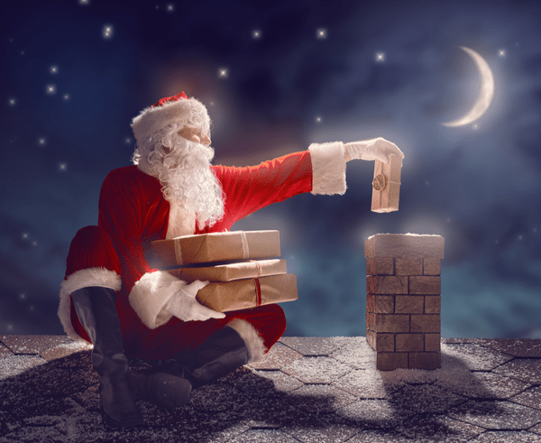 Santa sending presents down a chimney.