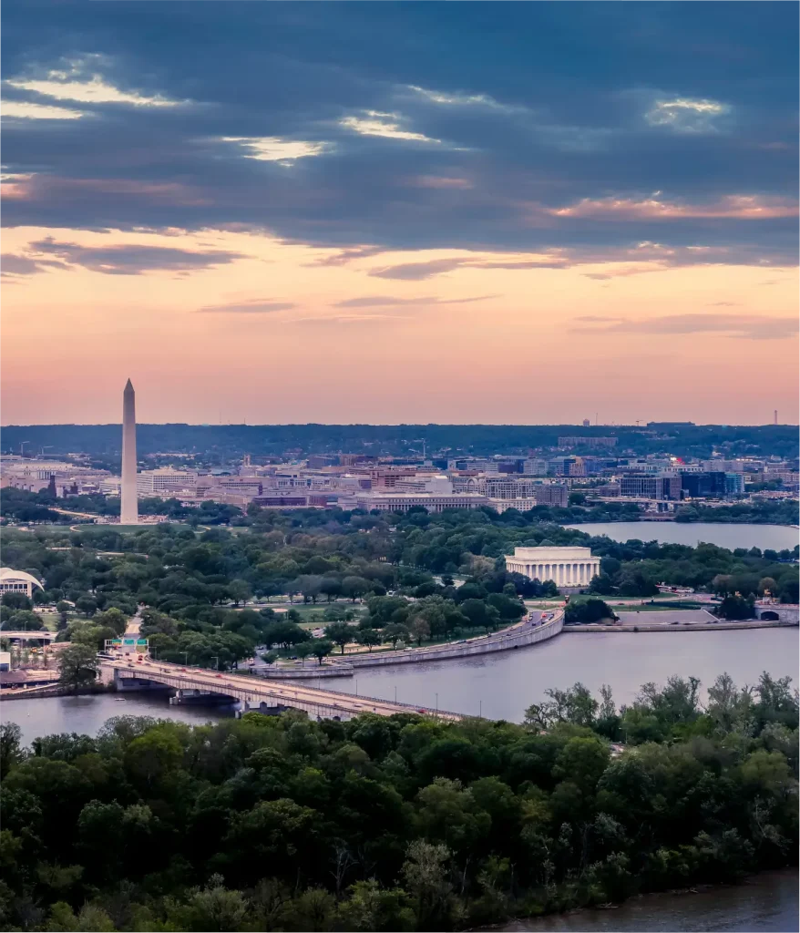Aerial view of Washington, D.C. at sunset featuring the Washington Monument, the Jefferson Memorial, and the Potomac River