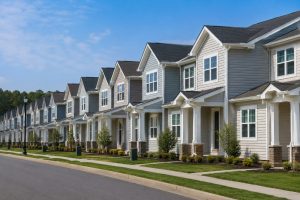 Row of well-maintained residential housing units with clean exteriors and landscaping