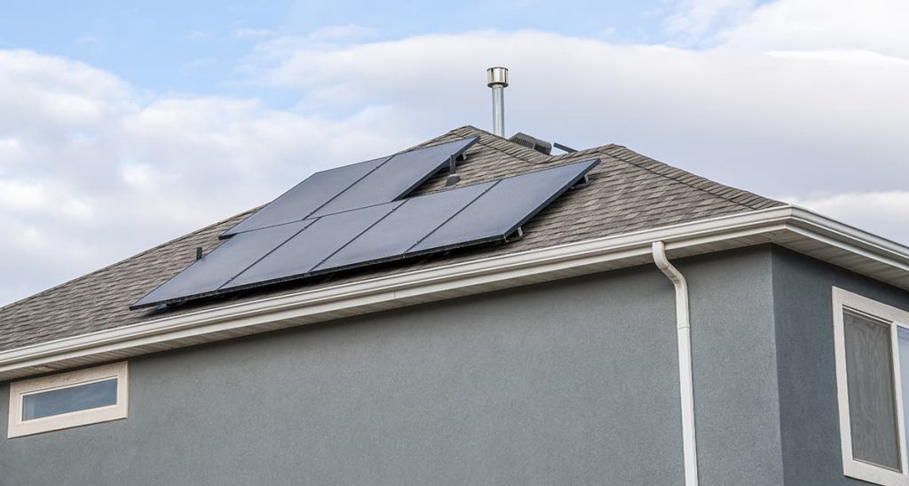 residential home roof with asphalt shingles and solar panels